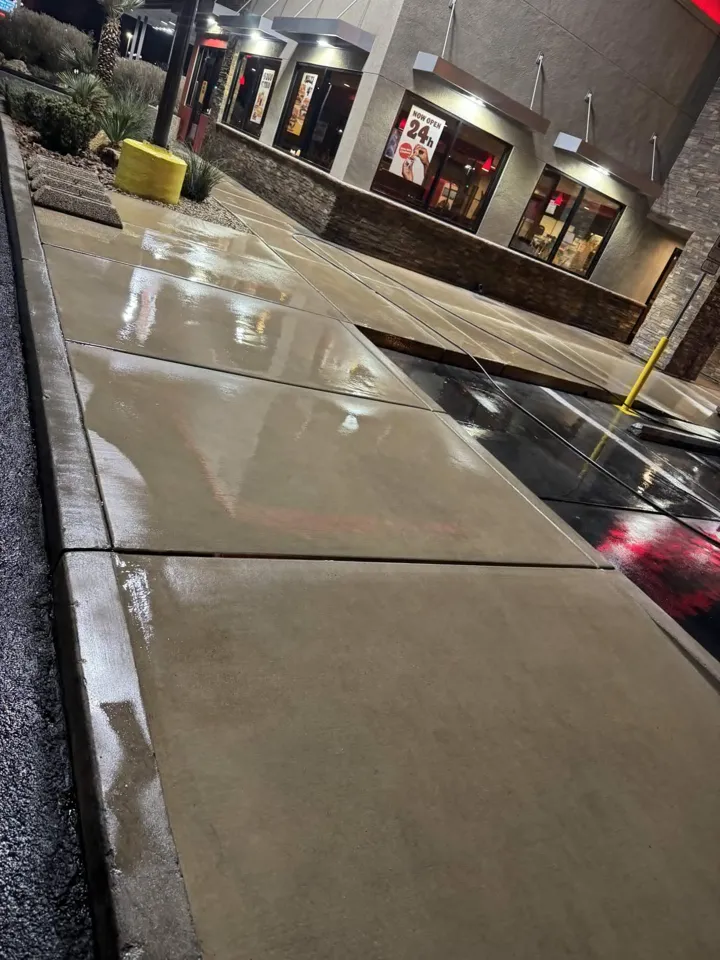 Wet, freshly cleaned commercial walkway in front of storefronts