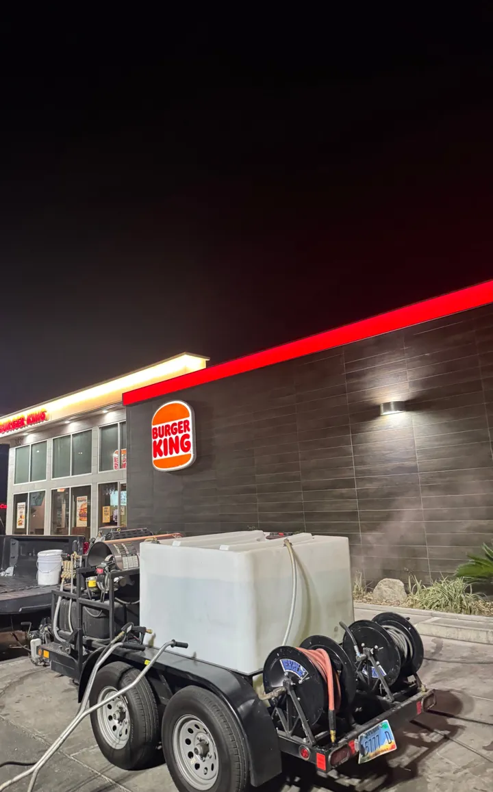Hot water power washing trailer at a restaurant at night